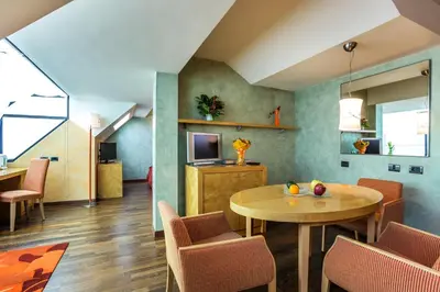 a living room with a table and chairs at Eurostars Sofia City in Sofia