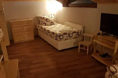 a small bedroom with a bed and a television at Duvaro Guesthouse in Raduil