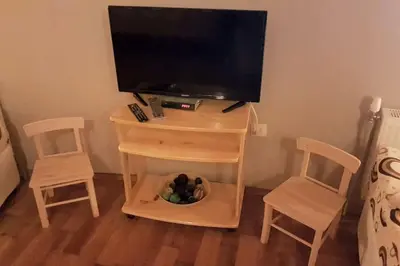a small table with a tv and two chairs at Duvaro Guesthouse in Raduil