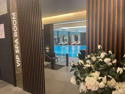 a lobby with a pool and a bouquet of flowers at Ramada by Wyndham Sofia City Center in Sofia