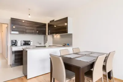 a kitchen and dining room with a table and chairs at Vitosha View One Bedroom Apartment by Flat Mаnager in Sofia