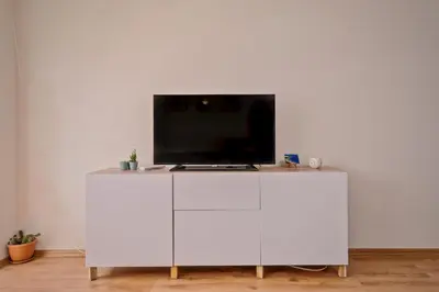 a white cabinet with a tv on top of it at Vitosha View One Bedroom Apartment by Flat Mаnager in Sofia