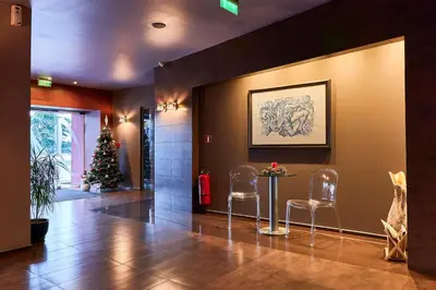 a lobby with a christmas tree and a table and chairs at Monet Hotel in Plovdiv