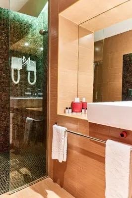 a bathroom with a sink and a mirror at Monet Hotel in Plovdiv