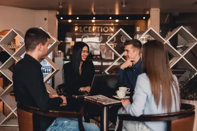a group of people sitting around a table in a coffee shop at Business Hotel Plovdiv - Central Location in Plovdiv
