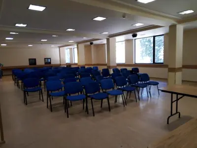 a large room with blue chairs and tables in it at Finlandia Hotel in Pamporovo