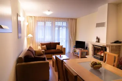a living room with a couch and a fireplace at The Castle Complex in Pamporovo