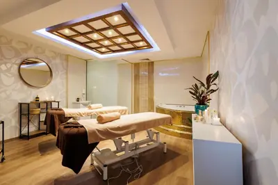 a therapy room with two beds and a mirror at Vihren Royal Palace in Bansko