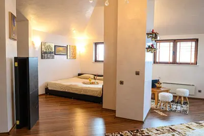 a bedroom with a bed and a table and chairs at Vihren Royal Palace in Bansko