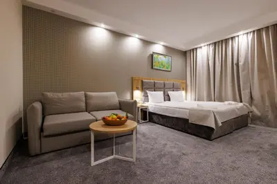 a hotel room with a bed and a couch at Vihren Royal Palace in Bansko