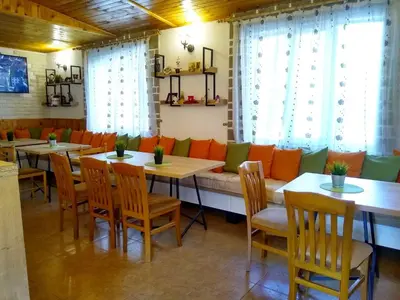 a restaurant with tables and chairs and a couch at Michel Hotel in Bansko