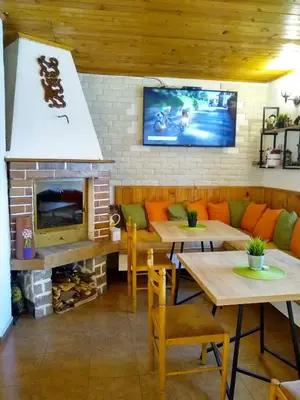 a restaurant with two tables and a fireplace at Michel Hotel in Bansko