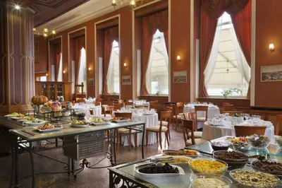 a dining room with tables filled with food at Ramada by Wyndham Plovdiv Trimontium in Plovdiv