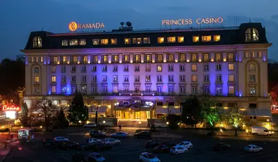 a large building with purple lights in a parking lot at Ramada by Wyndham Plovdiv Trimontium in Plovdiv