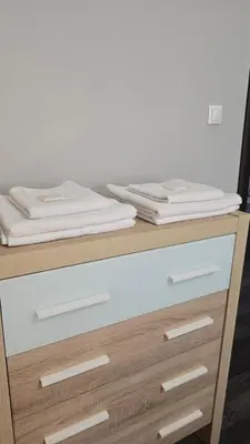 a wooden dresser with towels on top of it at Best Choice Apartment in Sofia