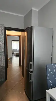 a kitchen with a stainless steel refrigerator in a room at Best Choice Apartment in Sofia