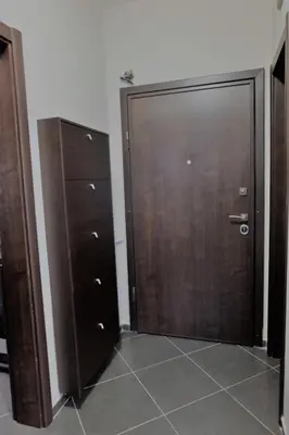 a pair of wooden doors in a room at Best Choice Apartment in Sofia