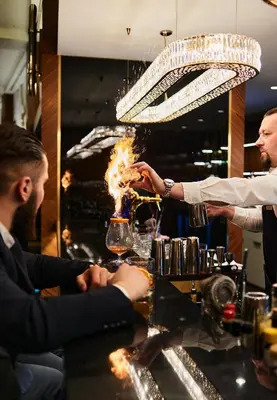 a bartender making a drink at a bar at InterContinental Sofia by IHG in Sofia