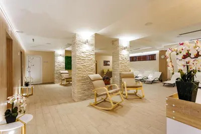 a lobby with a waiting room with chairs and tables at Spa Hotel Aspa Vila in Banya