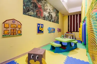 a childs play room with a table and a play set at Spa Hotel Aspa Vila in Banya