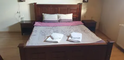 a large bed with two slippers on top of it at Villa Filip in Bachevo