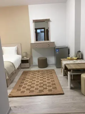 a bedroom with a bed and a checkerboard rug at Apartment Park Sveti Vrach in Sandanski
