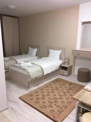 a bedroom with two beds and a checkerboard rug at Apartment Park Sveti Vrach in Sandanski