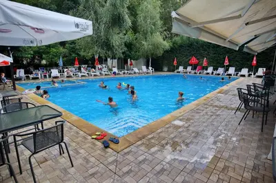 a group of people swimming in a swimming pool at Хотел Свети Трифон in Melnik