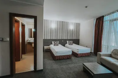 a living room with two beds and a couch at Hotel Noris in Plovdiv