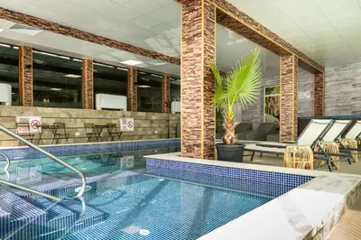a large swimming pool in a building at Zarevata Guest House in Velingrad