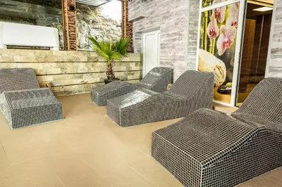 a group of wicker chairs sitting on a patio at Zarevata Guest House in Velingrad