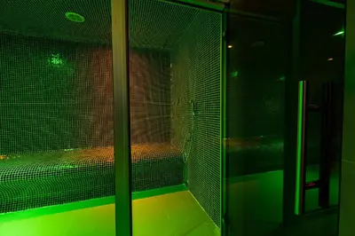 a room with a glass door with a green light at Zarevata Guest House in Velingrad