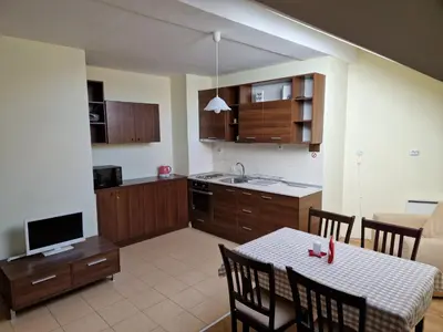 a kitchen and dining room with a table and chairs at Yastrebetz view in Borovets