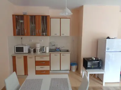 a small kitchen with a refrigerator and a microwave at Yastrebetz view in Borovets