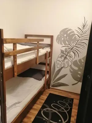 a room with two bunk beds and a rug at Pirin Heights in Bansko