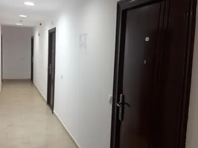 a hallway with a black door and a hallway with at Pirin Heights in Bansko