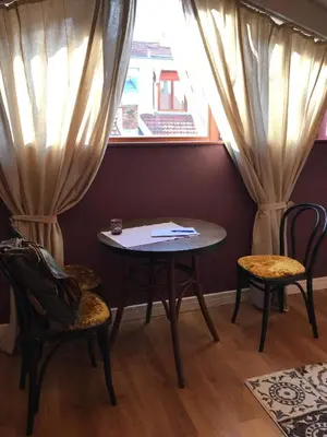 a table and chairs in a room with a window at Studio Maison 3 Kapana in Plovdiv