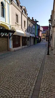 a cobblestone street in a city with buildings at Studio Maison 3 Kapana in Plovdiv