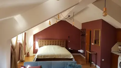 a bedroom with a large bed in an attic at Studio Maison 3 Kapana in Plovdiv