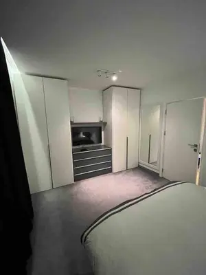 a bedroom with a bed and a tv in it at Lozenets Executive Apartment with Private Parking in Sofia