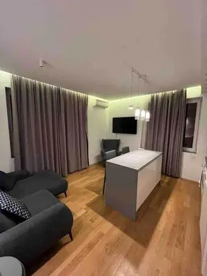 a living room with a couch and a table at Lozenets Executive Apartment with Private Parking in Sofia
