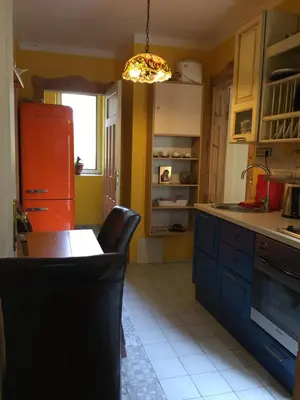 a kitchen with a table and a red refrigerator at Orient Express Guest House in Sofia