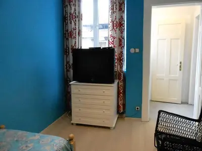 a bedroom with a television on a dresser with a window at Orient Express Guest House in Sofia