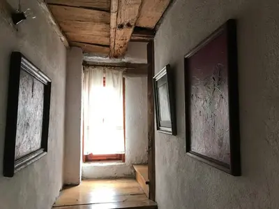 an empty hallway with a window in an old building at Das Landhaus in Bachevo