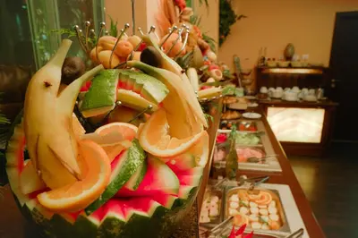 a fruit salad with oranges and other fruits on a table at Apartments Flora-Daisy in Borovets