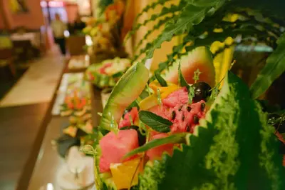 a plate of food with fruit on a table at Apartments Flora-Daisy in Borovets
