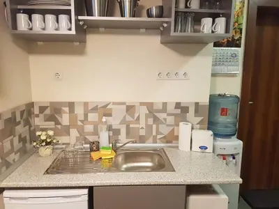 a kitchen with a sink and a counter top at Rooftop Oscar Rooms in Sofia