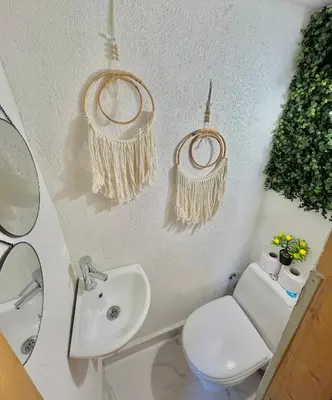 a bathroom with a toilet and a sink at Guest House Rila in Govedartsi