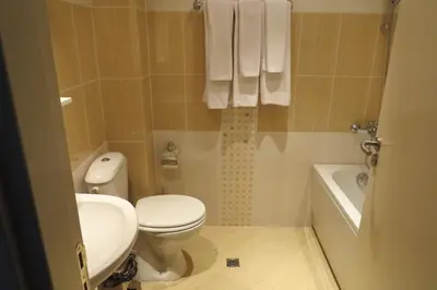 a bathroom with a toilet and a sink and a tub at Snowdrop Studio in Borovets