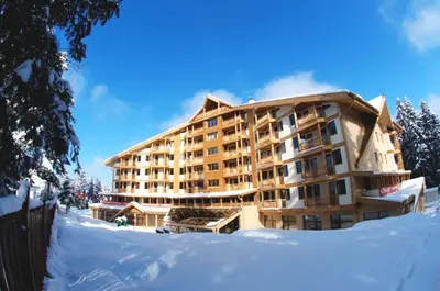 a large building with snow in front of it at Snowdrop Studio in Borovets